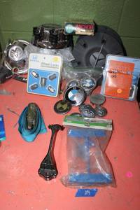 lot 29 image: Automotive lot battery hold down kit, strap, Honda wheel lock set, hub caps and more