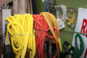 lot 35 image: Chrome display rack, rubber straps, plastic Split Wire Loom Conduit Tubing, universal icemaker connector as shown