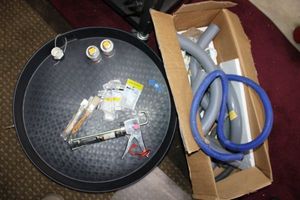 lot 40 image: Plumber supplies 2 water heater drain pans, Piping parts, chalking gun, Nylon hose barbs, all purpose cement