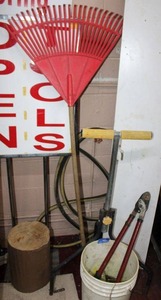 lot 45 image: Nails for nail gun, roller stand, branch trimmer, and yard rake