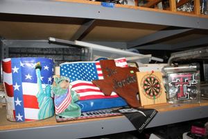 lot 127 image: Flag bag, plush Statue of Liberty bear, Texas Tech glass block and mini dart board