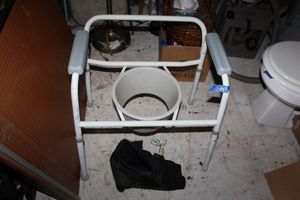 lot 145 image: Portable potty chair as shown and medical boot