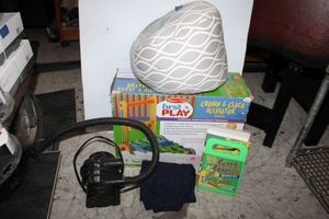 lot 203 image: Kids items nursing support pillow, games, toddler pants, Chomp & Clack Alligator push toy, and electric air pump