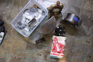 lot 257 image: Desk clocks, boss voodoo doll, and earbuds