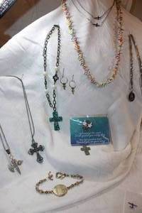 lot 304 image: Jewelry cross necklaces, cross earrings, guardian angel pin, and fishermans pride proverb figural fish necklace
