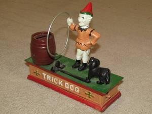 lot 72 image: Vintage Trick Dog cast iron coin bank