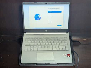 lot 137 image: Windows 11 HP Laptop Model14z-fq0000, Texas Instruments Briefcase, HP wireless Mouse, charging cable, and Cooling stand