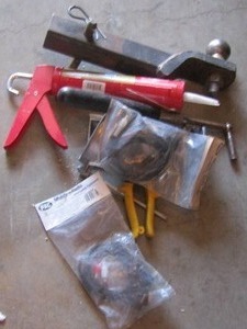 lot 105 image: tool lot - RECEIVER HITCH W BALL  TIN SNIPS, CAULK GUN, &  AUDIO WIRES NIP  see pics