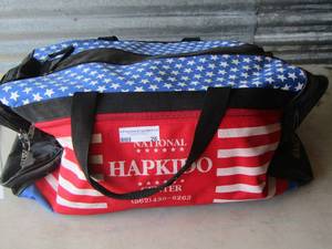 lot 26 image: boxing bag with boxing gloves and items inside