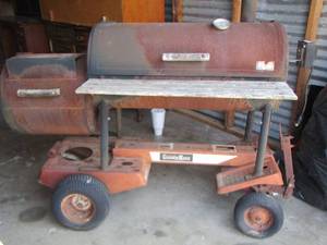 lot 360 image: HEAVY DUTY SMOKER  SET ON MOWER FRAME - HEAVY, IN GOOD CONDITION,  WHEELS DO GET STUCK