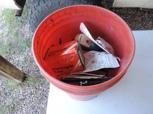 lot 29 image: 5 gallon bucket full of random things see picture spark plugs, strapped, and much more