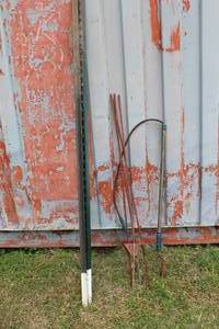 lot 179 image: Fence poles and fence brace poles and a plumbing snake