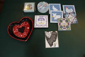 lot 215 image: coasters and a heart shaped plate and a heart shaped magnet