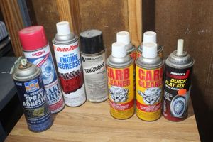 lot 194 image: Automotive Chemicles, Quick Flat Fix, Carb Cleaner 4 cans, Tekusolv 1 can, Engine Degreaser 1 can, Brake Parts Cleaner, 1 can and Spray Adhesive 1 can.