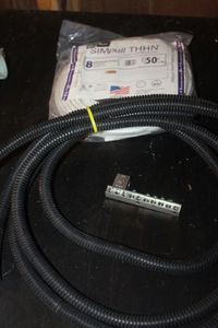 lot 326 image: Fifty Ft. 8 stranded Wire and wire protector
