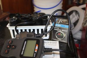 lot 473 image: OBD II Scanner, Impact Sockets, and 50 Amp Ampere Meter Gauge