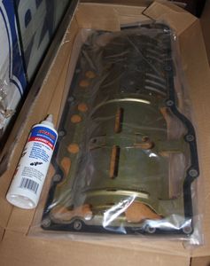 lot 46 image: Fuel filter 2002 Dodge Caravan  and a Mopar Oil Pan Gasket part Number 530215462AE Compatible With Jeep Grand Cherokee, Dodge Ram 1500, 2500, 3500, 2004 and up and some Chrysler Aspen & Ram Various Models wih 5.7L V8 Hemi Engines