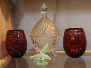 lot 31 image: Two hand blown red and gold swirl glasses and a glass candy dish and a dolphin figure