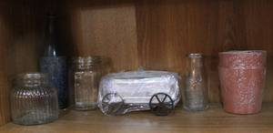lot 42 image: Small metal wagon with three seed pods and a self watering pot and some glass pieces see pictures