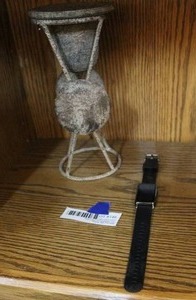 lot 146 image: Fitbit watch with out charger and a metal decorative piece