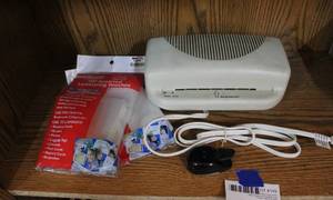 lot 149 image: Design Concepts YJ-3071 Portable Laminating MachineMSRP$119 and two packs of assorted laminate pouches and a punch