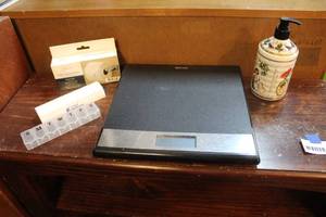 lot 152 image: Scale and toilet paper holder two medicine boxes and hand soap dispenser with soap in it