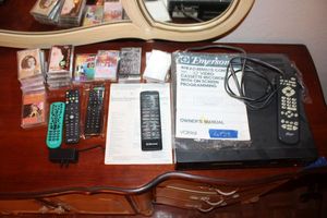 lot 23 image: Emerson VCR player with remotes and cassette tapes