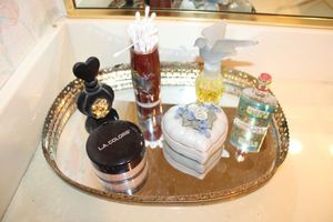 lot 29 image: Vintage vanity mirror and perfume bottles