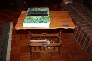 lot 58 image: Wooden magazine rack table with World Atlas book
