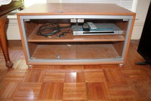 lot 55 image: Entertainment side table with glass doors and DVD player