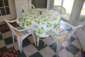 lot 38 image: Plastic patio set - table and 4 chairs with cushions