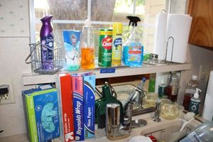 lot 100 image: Kitchen cleaners, plastic wrap, Reynolds wrap and gloves, plus stress mat