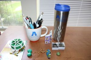 lot 48 image: UTA mugs and lapel pins, purple heart stamps, Misc. jewelry pieces and garden wire