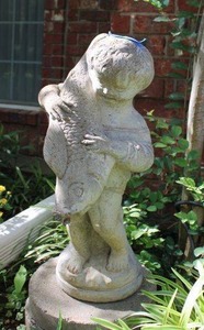 lot 166 image: Cement garden figurine boy with fish
