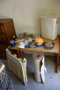 lot 142 image: Ball caps, 5 Lb. hand weights, flashlights, grilling items, retro yellow lounge chair, and carpet runner