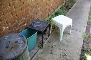 lot 155 image: Metal trash can, Patio side tables, wind chime