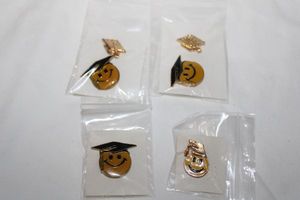 lot 282 image: Enamel fashion jewelry Graduation smile face pins