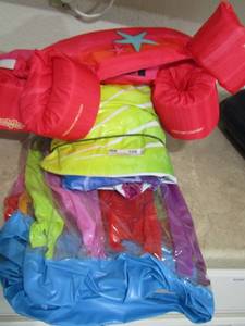 lot 109 image: 2 pink kids arm float jackets- folded up pool float