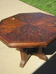 lot 50 image: OCTAGONAL Dark wood dining table , top is removable size unknown