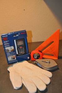 lot 308 image: Bosch Digital Measurer, Speed Square, Tape Measure and Chalk Line