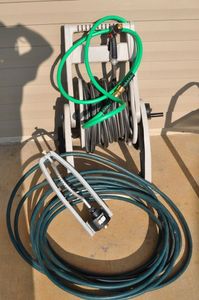 lot 330 image: One Very Long Water Hose on a Reel as well as other Shorter hoses and A Sprinkler