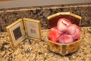 lot 147 image: Vintage Jennings Brothers Hinged footed Repousse Jewelry Trinket Box, Small Brass Colored Picture Frame and Floral hair Pins