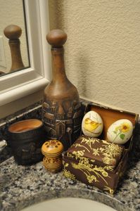 lot 150 image: Two Vintage Hand Painted Ceramic Eggs, Vintage Asian Fabric Jewelry Boxes, Vintage Wooden, Pepper Shaker from the USSR, and Vintage Ceramic Decanter with Stopper Bottle and Cup Set