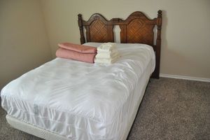 lot 202 image: Full size Bed, Includes Headboard, Frame, Mattress Cover (Mattress is available, Clean, always had a cover on it) Chaps Quilt and Sheet Set