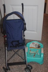 lot 79 image: Umbrellas Stroller with Sun Visor and Booster Seat, Straps hold it to the dinning room chair, Needs Cleaning