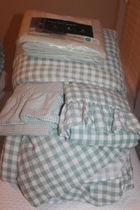lot 80 image: Twin XL Reversable Green and White Checked Comforter, Pillow Shams, Dust ruffle and New in Package Green Sheet Set