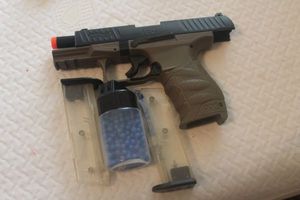 lot 105 image: Toy BB gun with two cartridges and A Bottle of Blue Plastic BBs