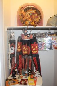 lot 110 image: Halloween Dcor and Fall Wreath, with Plastic Storage Container, Several windsocks, Gel Window Glings, Glow in the Dark Skelton, Wooden Home Dcor Pieces and Ceramic Dcor Pieces, Including a Night Light