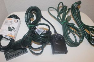 lot 115 image: Four Green Outdoor Extension Cords, some with Multi plugs, 1 timer with remote