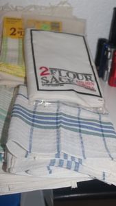 lot 215 image: Two Flour sacks and Kitchen Linens as shown